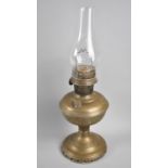 A Vintage Brass Oil Lamp with Glass Chimney