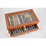 A Modern Two Drawer Pen Cabinet with Glazed Top containing 24 Mixed Pens, 34cms Wide