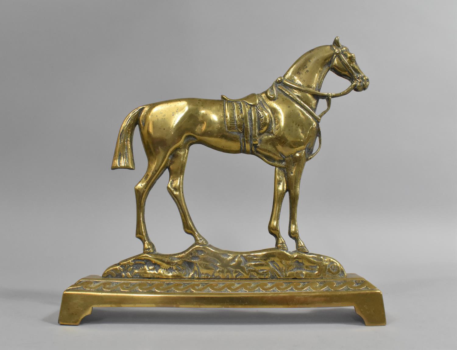 A WWI Period Brass Door Stop in the Form of a War Horse, 23cms Wide