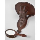 A Small Black Forest Carved Wooden Sconce Shelf with Chamois Support together with a Miniature