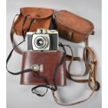 Two Leather and One Canvas Camera Cases together with a Kodak Brownie 44b Camera