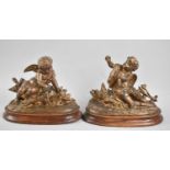 A Pair of Continental Bronzed Spelter Studies of Cherubs on Oval Naturalistic Bases with Wooden