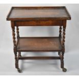 An Edwardian Oak Barley Twist Two Tier Trolley with Lift and Twist Galleried Top, 76cms Wide