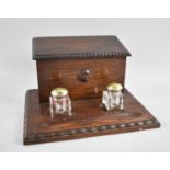 An Edwardian Oak Desk Top Ink Stand and Stationery Store with Two Glass Ink Bottles, Hinged Lid to