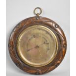 An Edwardian Oak and Brass Circular Wall Hanging Aneroid Barometer, 21cms Diameter