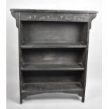An Edwardian Ebonised Three Shelf Open Bookcase with Carved Top Rail, 92cms Wide