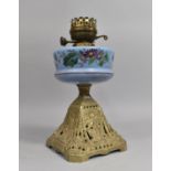 A Late Victorian Cast and Pierced Iron Based Oil Lamp with Opaque Blue Glass Reservoir Decorated