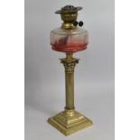 A Victorian Brass Oil Lamp of Corinthian Column Form with Clear Glass Reservoir, Stepped Square