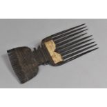 A 19th Century African Tribal Comb with Roudel Design having Paper Label. 24.5cms Long