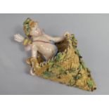 A Late 19th/Early 20th Century Continental Majolica Glazed Wall Pocket in the Form of Cupid Standing