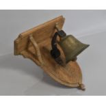 An Early 20th Century Servants Bell Mounted on an Oak Plaque, 32x30cms