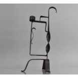 A Wrought Iron Rush Light, Tri Footed with Back Twisted Support Culminating into Hook, 31.5cms High