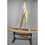 A Late 19th Century Wooden Pond Yacht Hull with Mast, Boom, Sails and Cradle, 121cms Long