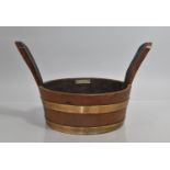 A Mid 20th century Brass Bound Teak Two Handled Bowl made from the Timber Salvaged from WWII