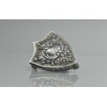 An Edward VII Silver Trinket Box of Heraldic Shield Form having Repousse Scroll Work and Centre