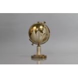 A Mid 20th Century Novelty Desktop Cigarette Dispenser in the Form of a Globe, Splitting and the