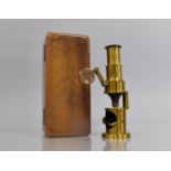 A Brass Field Microscope Housed in Wooden Fitted Case, 14cms high and Case 16.5x7.5x5.5cms