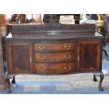 An Edwardian Serpentine Front Mahogany Sideboard with Three Centre Drawers Flanked by Two Cupboards,