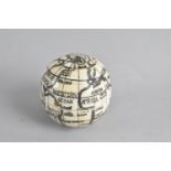 A Reproduction Scrimshaw Pocket Globe of Hinged Form with Inner Compass and Sundial, 4cms Diameter
