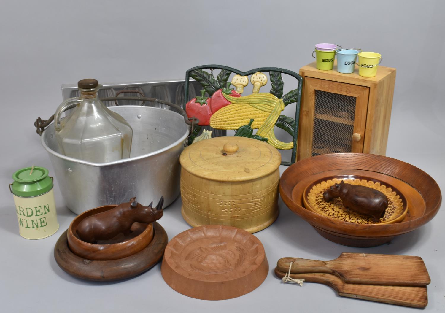 A Collection of Various Kitchen Sundries to Include Cast Iron Recipe Book Stand, Jam Pan, Egg Box