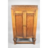 An Edwardian Oak Fitted Cabinet with Hinged Top to Storage Area, Panelled Doors to base Cupboard,
