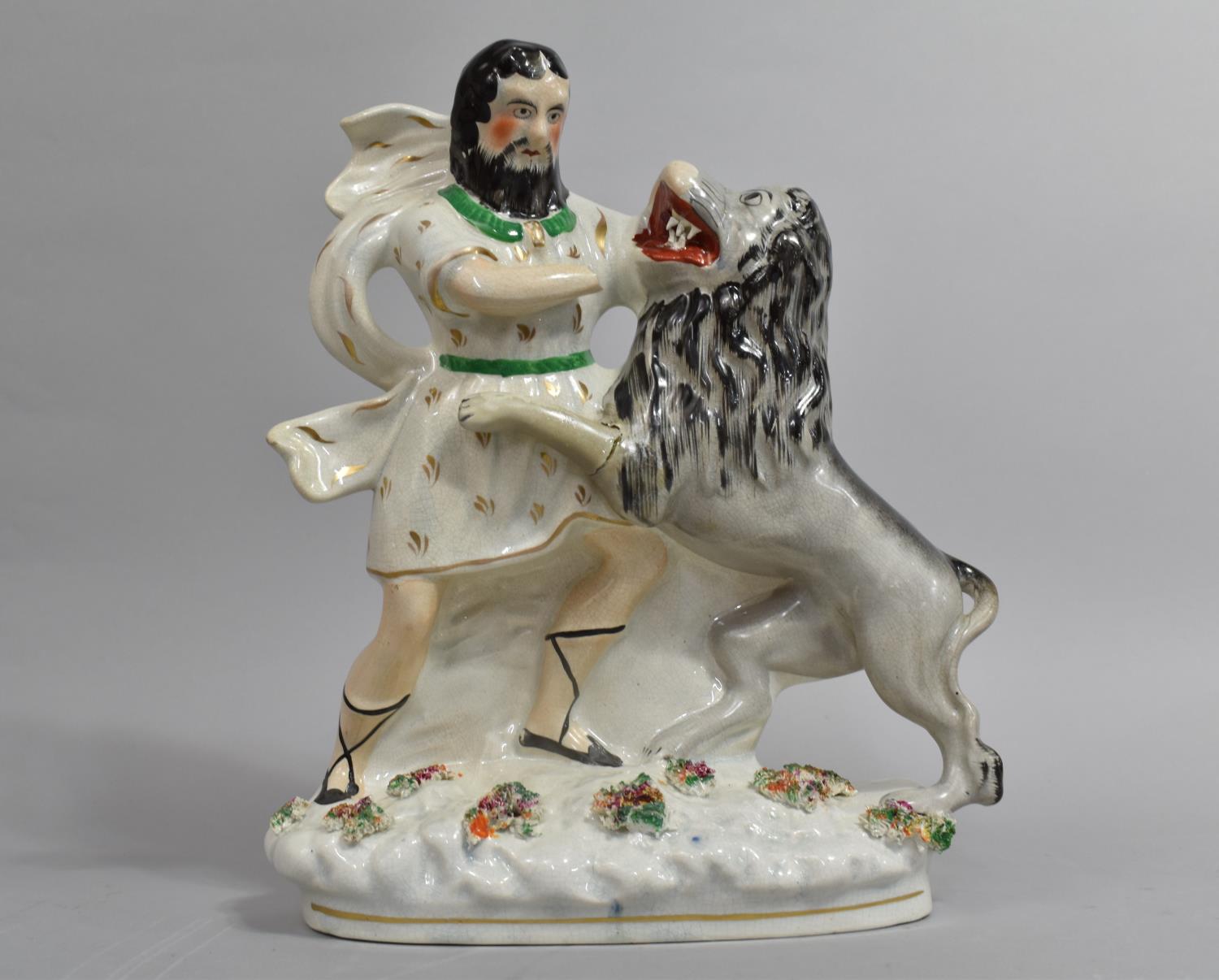 A Late 19th Century Staffordshire Biblical Figure, Daniel in the Lions Den, 27cm High (AF)