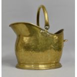 A Mid 20th Century Hammered Brass Helmet Shaped Coal Scuttle, 39cms High Overall