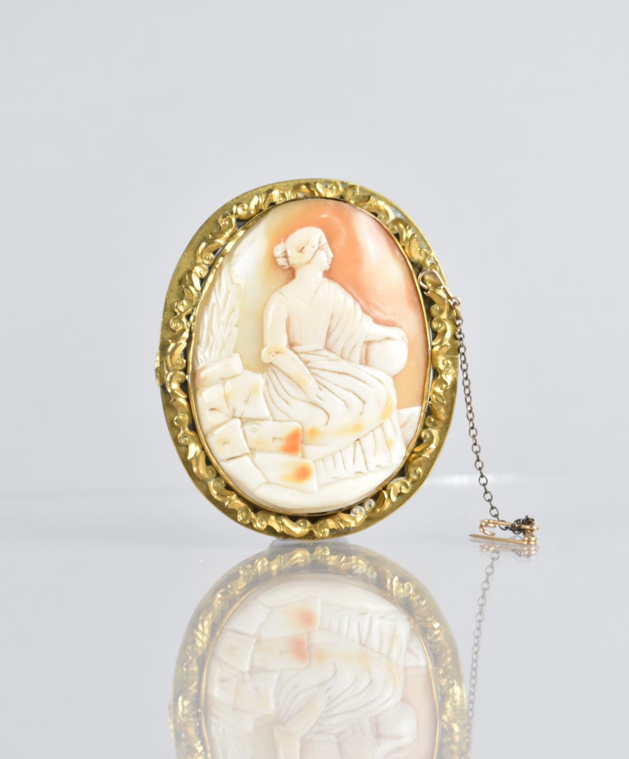 A Large Victorian Shell Cameo Brooch depicting Classical Maiden, Possibly Virgo, Seated on Rocks and