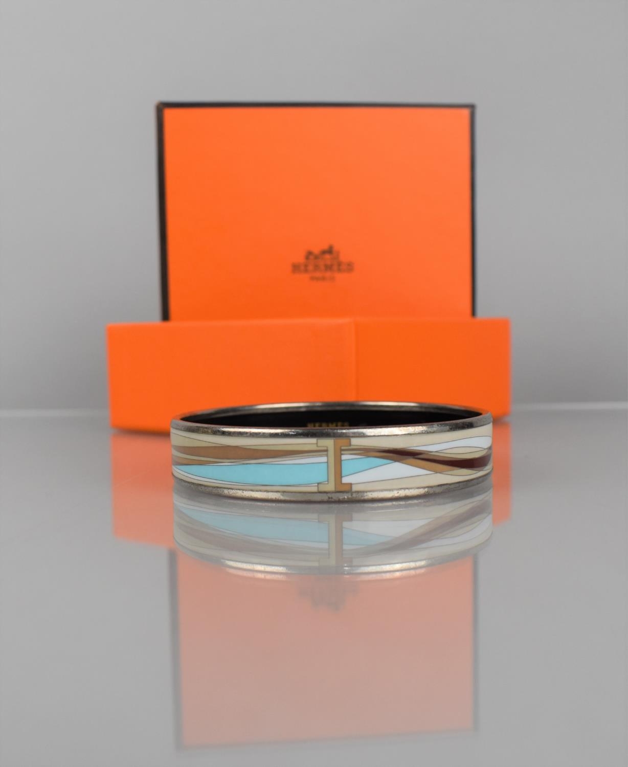 A Hermes Enamelled Bangle, Beige, Maroon and Pale Blue with Applied Chromed Metal Border, (One Loose