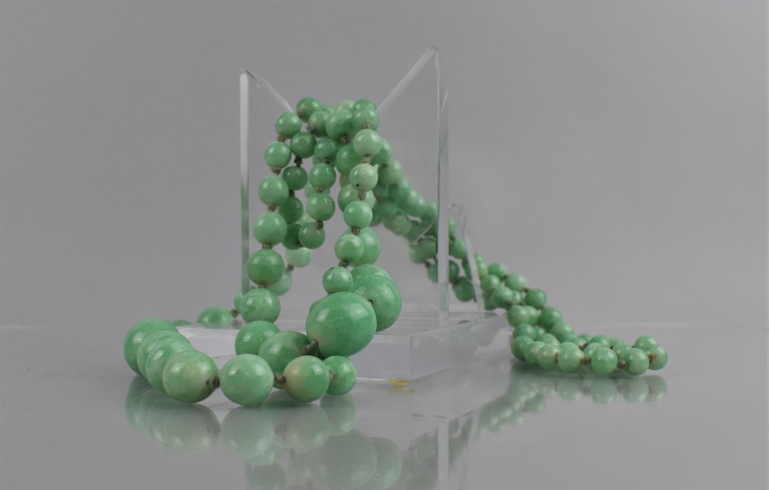 A Double String of Early 20th Century Faux Applegreen Jade Graduated Ovoid Beads, Longest Length