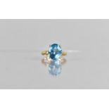 A 9ct Gold and Sapphire Dress Ring, Centre Oval Cut Stone 13mm x 10mm in a Four Claw Setting to a