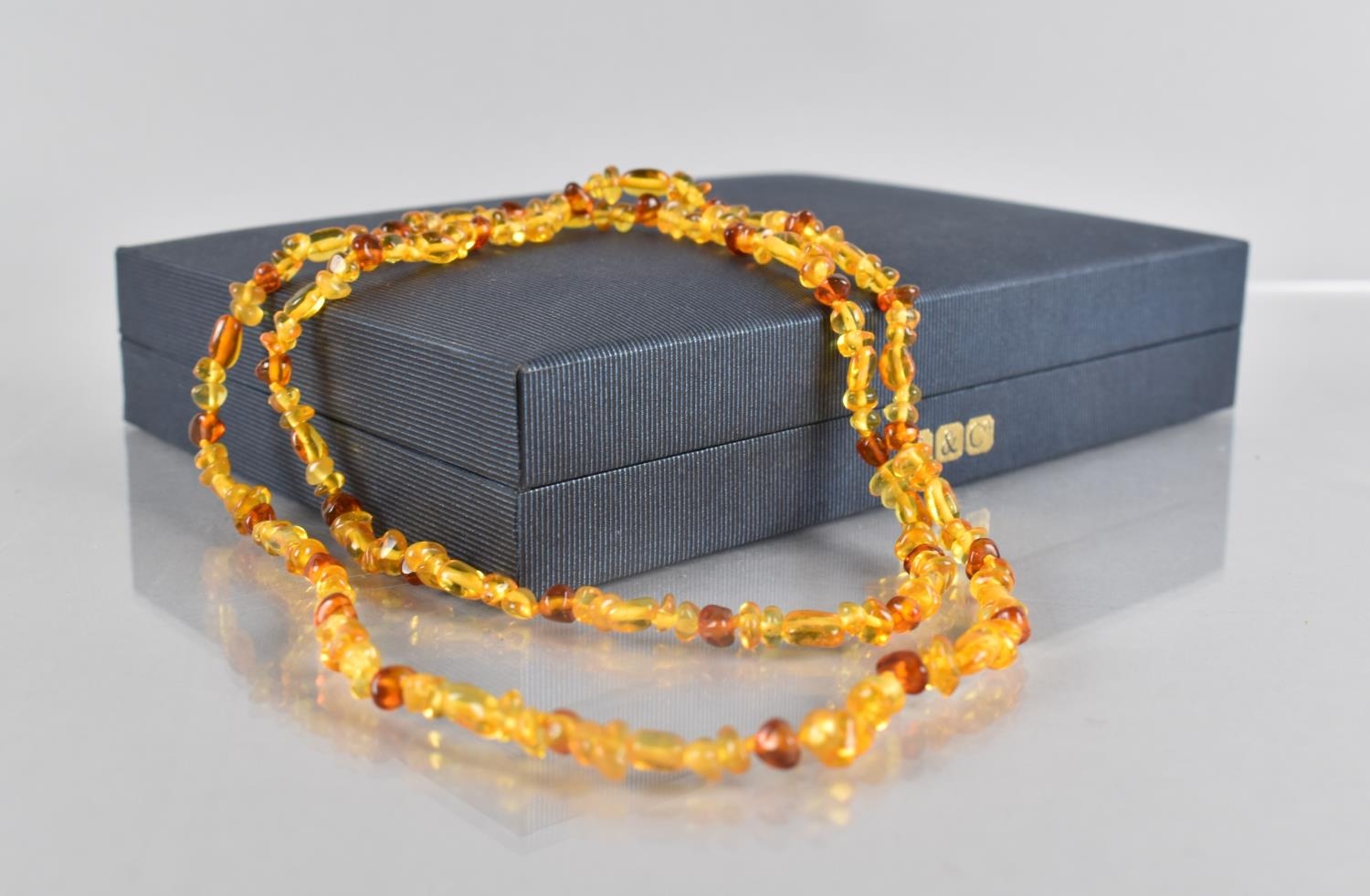 A String of Polished Baltic Amber Beads, 68cms Long Approx