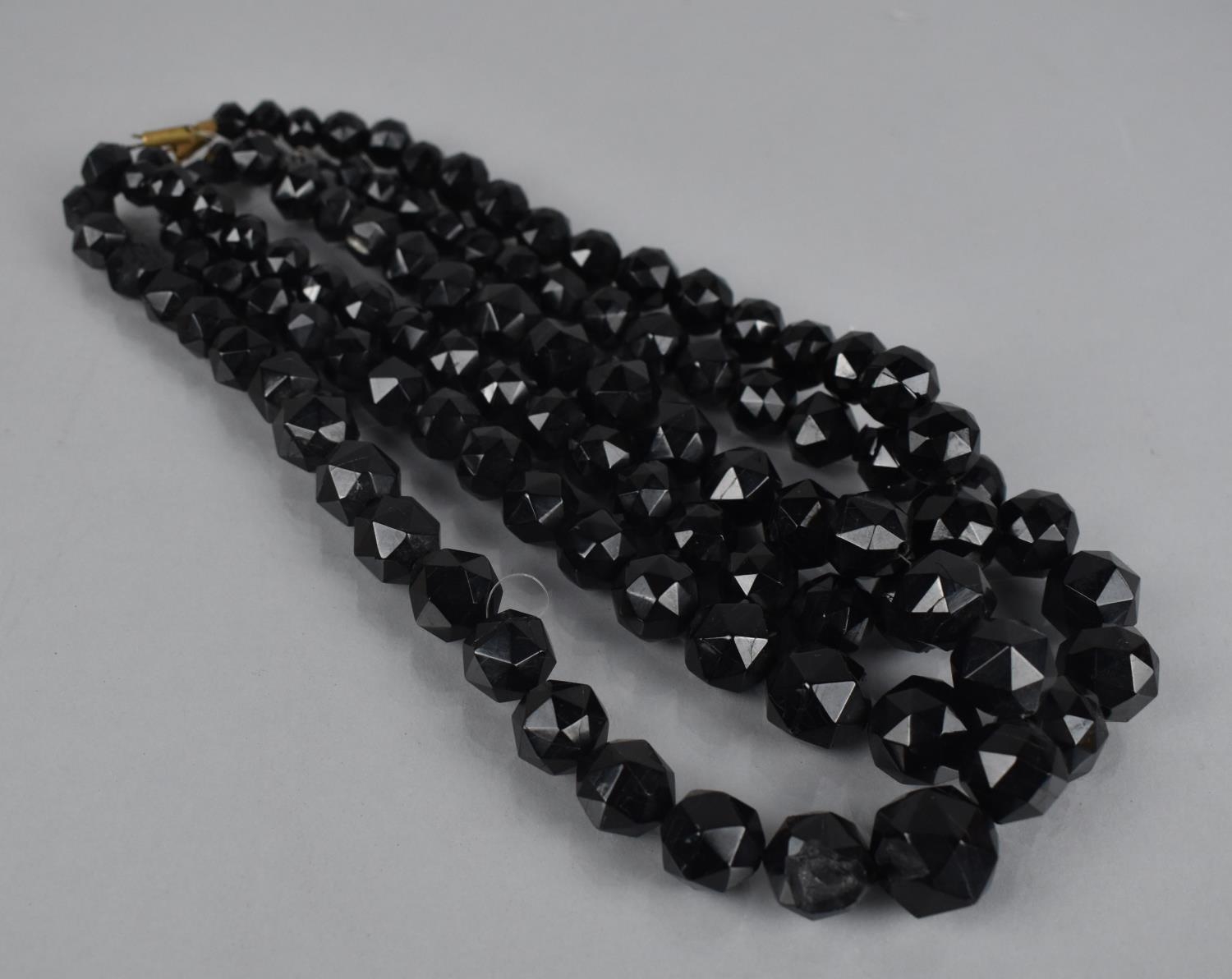 Three Strings of Graduated Faceted Ovoid Jet Beads together with Two Jet Brooches, One with Mother - Image 2 of 2