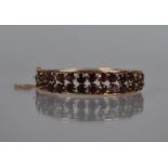 An Eastern 14ct Gold and Garnet Mounted Hinged Bangle, Two Rows of Round Cut Stones Approx 4mm