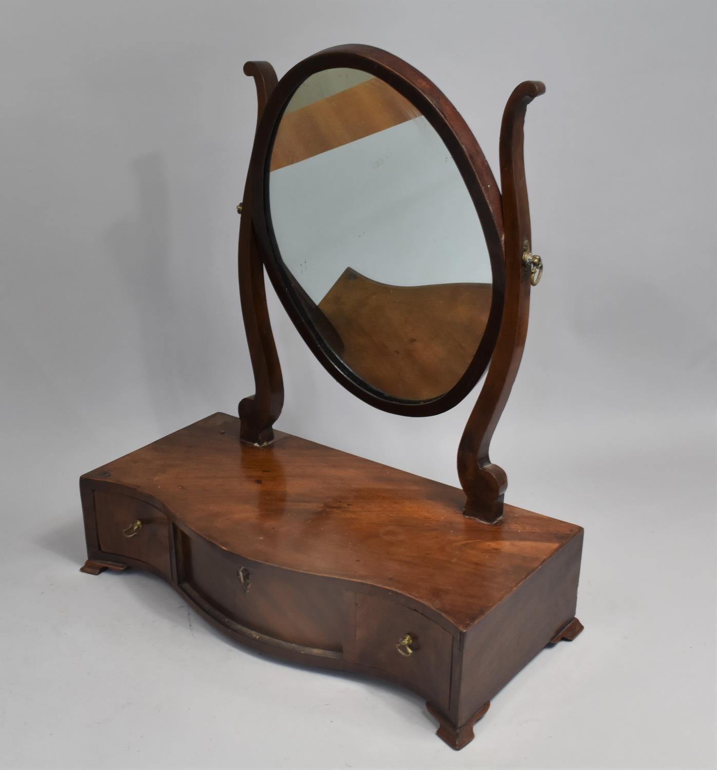 A 19th century Mahogany Serpentine Fronted Dressing Table Mirror with Plinth Base having Three