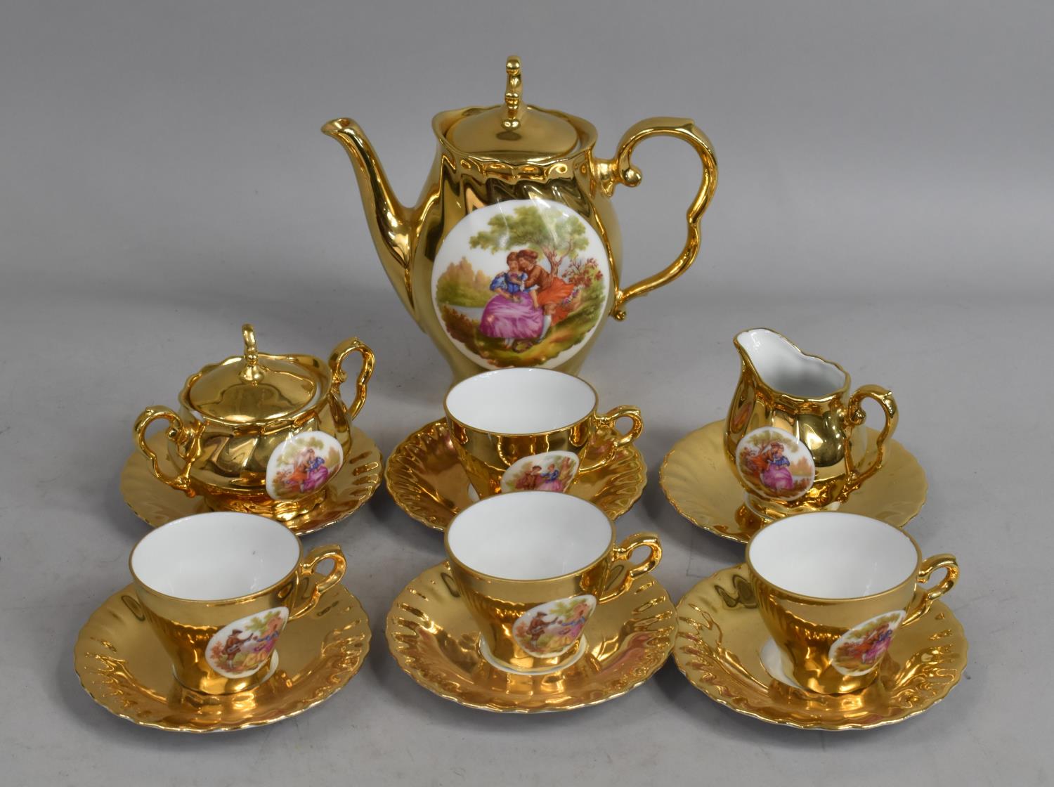 A German Gilt Service to Comprise Four Cups, Six Saucers, Lidded Sugar, Jug and a Coffee Pot