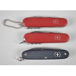 A Collection of Three Victorinox Swiss Army Knives