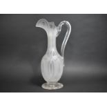 A Cut and Frosted Glass Ewer with Heavy Looped Handle on Circular Foot having Sunburst Cut Design,