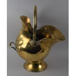 A Pressed Brass Helmet Shaped Coal Scuttle with Loop Handle, 50cms High