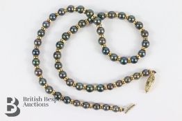 Black Pearl and Gold Bead Necklace