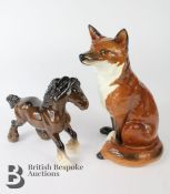 A  Beswick fireside figure of a seated fox marks to base Ht 31cms, model no.2348, together with a