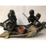 TWO VINTAGE CERAMIC AFRICAN FIGURES ON BOATS. A/F. THE LARGEST IS 67CM X 31CM.