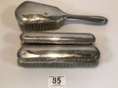 THREE VINTAGE 800 STAMPED SILVER-BACKED BRUSHES, TWO BEING A PAIR.