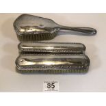 THREE VINTAGE 800 STAMPED SILVER-BACKED BRUSHES, TWO BEING A PAIR.