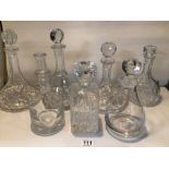 SEVEN MIXED UNMARKED CRYSTAL AND GLASS DECANTERS WITH STOPPERS.