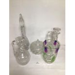 FIVE PIECES OF VINTAGE CUT GLASSWARE. INCLUDES THREE DECANTERS WITH STOPPERS, A VASE, AND A LIDDED