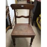 A WOODEN BAR BACK CHAIR