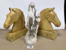 A PAIR OF VINTAGE ALABASTER HORSE HEAD BOOKENDS WITH A METAL STATUE OF A MAN REARING A HORSE.