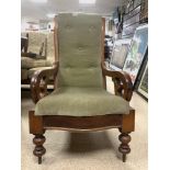 A VICTORIAN MAHOGANY FRAMED SCROLL ARM EASY CHAIR ON TURNED FRONT LEGS