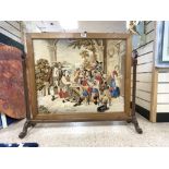 A FREE STANDING FRAMED MAHOGANY TAPESTRY OF THE 3 MUSKETEERS WITH MONK AND LADY WITH A DOG 80 X 70